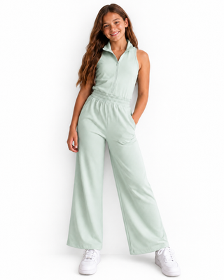 Girl wearing a light green jumpsuit on a white background