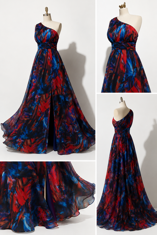 A one-shoulder floor-length gown displayed on a mannequin in a collage layout. The dress has an abstract painterly pattern in deep red, royal blue, and black, with a fitted bodice and flowing skirt.
