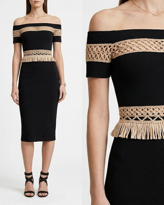 Black off-shoulder dress with beige lace and fringe details on a white background