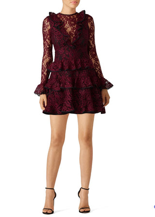 Red lace dress with ruffled details on a white background