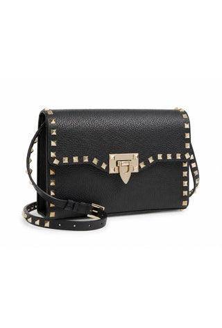 A black pebbled leather shoulder bag with gold-toned studs along the edges and strap, and a central gold-toned clasp, shown on a plain white background.