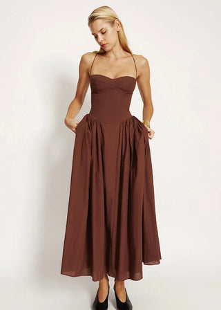 Woman wearing a brown dress on a white background