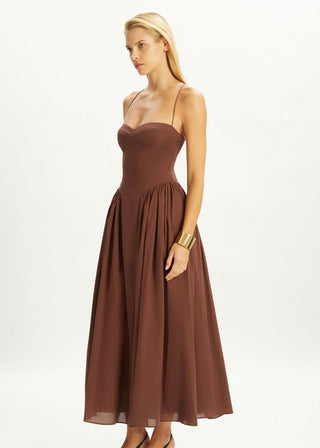 Woman wearing a brown dress on a white background