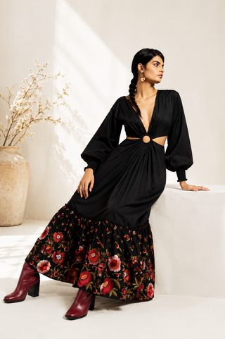 Woman wearing a black dress with floral skirt in a minimalistic setting