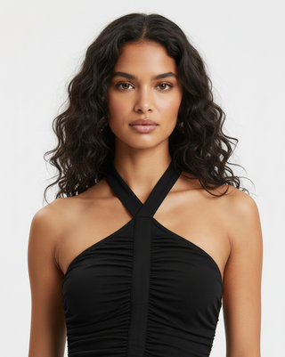 Woman wearing a black halter top against a white background