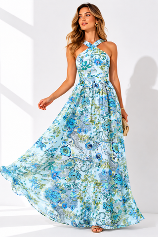 Woman wearing a blue floral dress against a white background