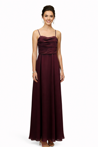 Woman wearing a burgundy evening gown on a white background