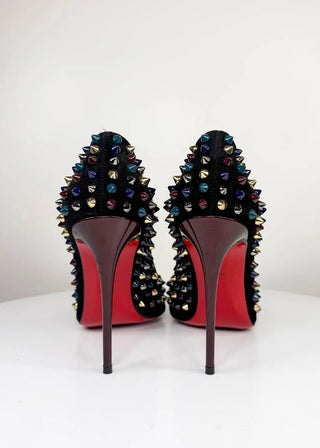 A pair of black pointed-toe high heels with multicolor rhinestone embellishments on the upper and a signature red sole, photographed from the back against a white background.