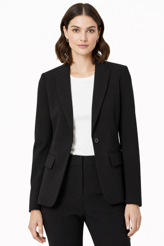 Woman wearing a black suit jacket and pants on a white background