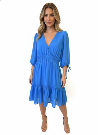 Woman wearing a blue dress on a white background