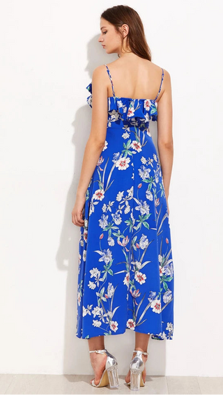 Woman wearing a blue floral dress against a white background