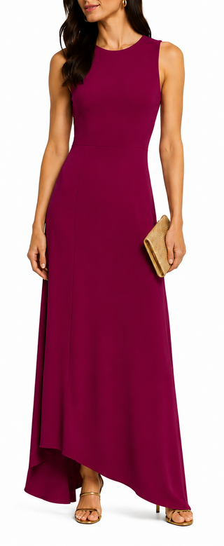 Woman wearing a sleeveless burgundy evening gown holding a clutch.