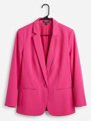 Pink blazer on a hanger against a white background