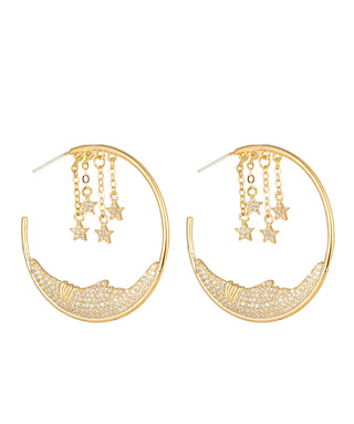 Gold hoop earrings with star charms on a white background