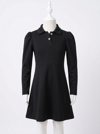 Black dress on a mannequin against a white background