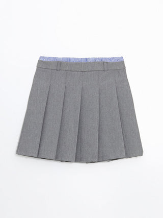 Gray pleated skirt with a blue and white striped top on a white background