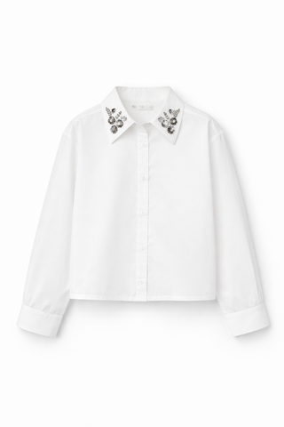 White blouse with embellished collar on a white background