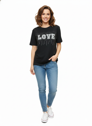 Woman wearing a black t-shirt with 'LOVE' and blue jeans on a white background