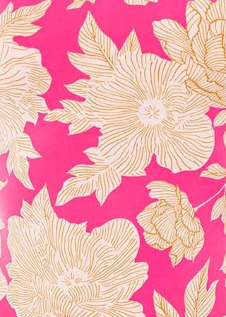 A close-up of a floral patterned fabric or wallpaper featuring large cream-colored flowers and leaves with gold linework on a bright pink background.