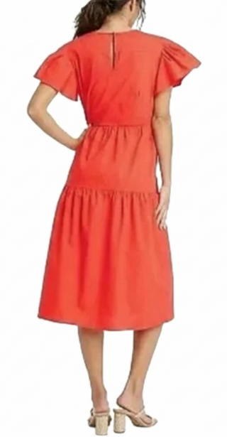 Woman wearing a red dress on a white background