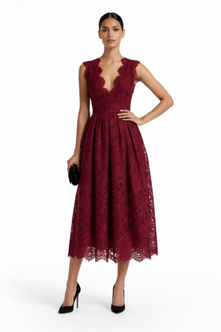 Woman wearing a burgundy lace dress on a white background