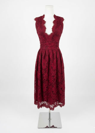 Red lace dress on a mannequin against a white background