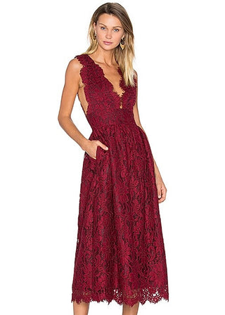 Woman wearing a burgundy lace dress on a white background