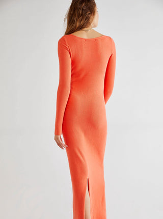 Coral long-sleeve dress with a slit on a white background