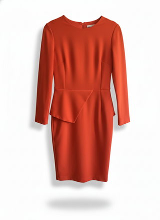 Orange dress with a peplum detail on a white background