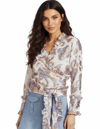 Woman wearing a patterned blouse with a white background