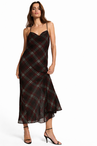 Woman wearing a black plaid dress on a white background