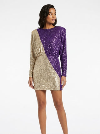 Woman wearing a gold and purple sequin dress on a white background