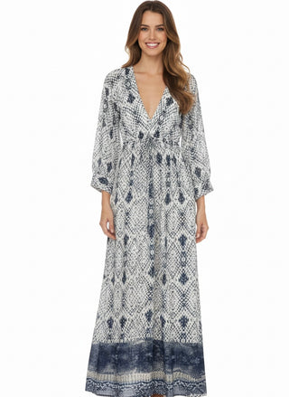 Woman wearing a patterned long dress on a white background