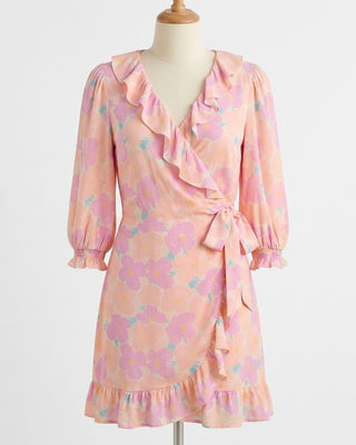 Pink floral dress on a mannequin against a white background