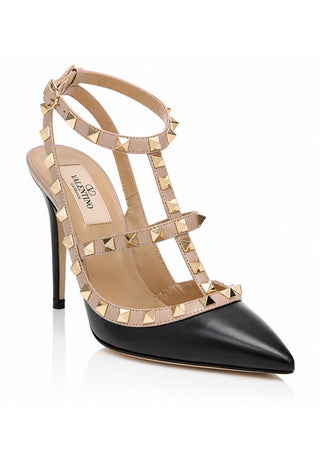 A Valentino high-heeled pump featuring a black leather pointed toe and a beige leather upper adorned with gold-tone pyramid studs, shown on a white background.