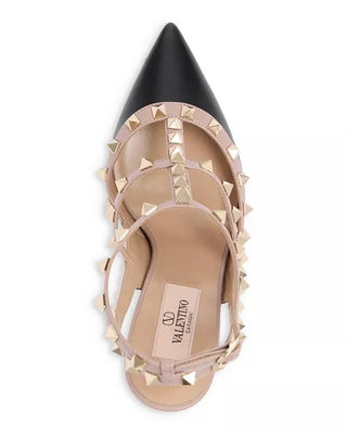 A single Valentino pointed-toe flat sandal shown from a top-down view. The shoe features a black leather pointed toe cap, a beige leather upper with crisscrossing straps, and prominent gold-tone pyramid studs around the perimeter and along the straps.