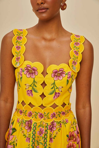 Yellow floral dress with intricate patterns on a neutral background