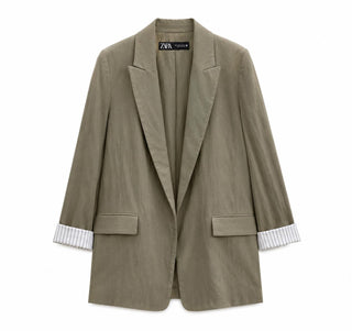 Green blazer with striped cuffs on a white background
